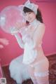 A woman in a white lingerie holding a large bubble.